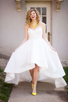 a woman wearing a white dress and yellow shoes