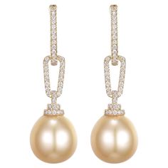 Behold the understated elegance of these 14K yellow gold earrings, each featuring a South Sea pearl with a natural, gentle form. Measuring approximately 12.5 x 15mm, the pearls are not perfectly round, a characteristic that enhances their unique appeal and authentic beauty. Subtle marks on the pearls' surface speak of their journey through the ocean's depths, telling a story as old as time itself. A trail of 0.64 carats of sparkling diamonds descends to meet each pearl, their brightness set in sharp relief against the warm golden tones. These jewels are a masterclass in harmony, balancing imperfection with the precision of diamond adornment. These earrings are a celebration of nature's artistry, perfect for those who seek elegance with a touch of individuality. Ideal for various occasions, Pearl Diamond Dangle Earrings, Authentic Beauty, Yellow Gold Earrings, Diamond Dangle Earrings, Earring Ideas, Sea Pearl, Pearl Earring, South Seas, South Sea Pearls