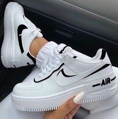 a woman's white nike air force sneakers with black and white lettering on them