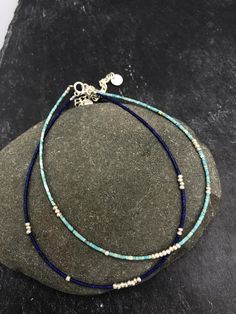 This handmade anklet is composed of natural lapis lazuli OR turquoise and silver beads, placed randomly along the string. It closes with a simple spring ring and we added 4 cm silver chain that allows for a slight size adjustment. All silver parts are hand crafted in 95-98% Silver by Thai Karen hill-tribe artisans. The Karen are a group of ethnic peoples who reside primarily in southern and southeastern Burma and in northern and north-eastern Thailand. Every piece is handmade and individual. The Handmade Blue Sterling Silver Beaded Bracelets, Blue Beaded Bracelets With Sterling Silver Gemstone Beads, Sterling Silver Blue Jewelry With Tiny Beads, Blue Sterling Silver Jewelry With Tiny Beads, Blue Anklet With Tiny Beads For Gift, Blue Tiny Beads Anklet For Gift, Blue Dainty Anklets For Gift, Silver Beaded Lapis Lazuli Bracelets, Blue Round Beads Anklets For Gifts