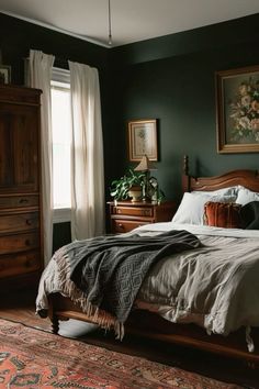 a bed sitting in a bedroom next to a window