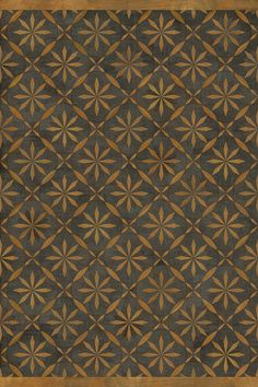 a brown and black area rug with an intricate design on the center, in front of a wooden frame