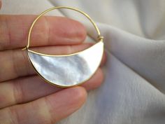 * Medium Mother of Pearl Crescent Moon Hoops. * Pair of hoops. * Gold-tone (Brass) bezel. * 4.5 cm diameter hoop. To see these earrings in SILVER: https://www.etsy.com/listing/568946721/silver-mother-of-pearl-moon-earrings Mama luna watches over each one of us. She rules the tides and our moon cycles, she tugs and pulls at our heart strings, encouraging us to open up to mama earths rhythms. Each beautiful and light-weight piece of mother-of-pearl is carefully and securely framed with brass, and Round Earrings With Moon Charm For Anniversary, Unique Moon Charm Round Earrings, Unique Round Moon Charm Earrings, Brass Half Moon Earrings For Gift, Gift Moon Charm Round Earrings, Gift Round Earrings With Moon Charm, Gift Round Moon Charm Earrings, Half Moon Ear Wire Jewelry Gift, Half Moon Ear Wire Jewelry For Gift