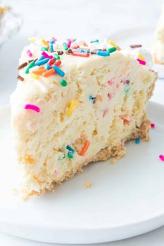 a slice of birthday cake with sprinkles on it is sitting on a plate