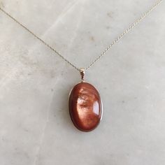 This stunning Pendant is set in 14k Solid Yellow Gold with Natural Sunstone (Feldspar Crystal) with utmost precision. It is a unique gemstone Pendant for nearly every occasion and is completely hassle-free jewelry. ITEM DETAILS: *  GEM: Sunstone * GEM SIZE: 18x27mm * GEM SHAPE: Oval * Gem WEIGHT: 36.83 carats * Gold Purity: 14KT * Gold Weight: 0.75 gram * Total Weight: 8.13 gram The Gold purity is guaranteed and it comes with authentic 14KT gold hallmark. Since my items are handmade, they are absolutely nickel and lead free. CUSTOMIZATION: * Gemstone customization is available and it can be substituted with a gem of your choice. Kindly message me for the same. PACKAGING * The Pendant comes with layers of safe and secure wrapping along with Free handmade jewelry box with every purchase. ➡️H Gold Cabochon Gemstones For Formal Occasions, Formal Gold Cabochon Gemstones, 14k Gold Oval Amber Jewelry, Luxury Gold Oval Cabochon Gemstones, Polished Yellow Gold Oval Cabochon Gemstones, Yellow Gold Polished Oval Cabochon Gemstones, Elegant Gold Cabochon Gemstones, Yellow Gold Oval Cabochon Gemstone With Polished Finish, Fine Jewelry Cabochon Gemstone Pendant