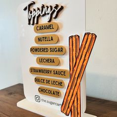 there is a sign with some type of food on it that says topiary caramel, nutella, powdered sugar, lechera, strawberry sauce, dulce and juice de lice