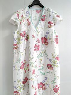 Oversized 100% Cotton Nightgown Flower Print 4XL - women giift This nightgow has a very elaborate design, but at the same time very comfortable. This cotton is the softest against the skin, washes beautifully without the usual wrinkling and is light weight. Perfect for lounge wear or sleep. Simple V scoop neckline with lace.  Size is chosen by bust measured at fullest which is all the way around and across the center of bust (not bra size) and length is measured from shoulder down, over the bust, to the length you want. Plus size it is any measurement, bust, waist, hips that measure over 48". Dimensions of dress: bust - 52 inch (132 cm),  robe length 47 inch (120cm) Shipping time: please see the shop policies for a full shipping information: https://www.etsy.com/shop/VikiSleepLine/policy?r Cotton Floral Print V-neck Sleepwear, Spring Short Sleeve Sleepwear For Home, White Floral Print V-neck Sleepwear, Spring Sleepwear With Short Sleeves For Home, Floral Print Short Sleeve Sleepwear For Comfort, Cotton V-neck Sleepwear With Floral Print, Short Sleeve Floral Print Nightgown For Home, Floral Print V-neck Sleepwear For Loungewear, Spring Floral Print Short Sleeve Sleepwear