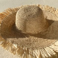 "Crochet Raffia Sun Hat with Fringe A beautiful handmade sun hat for the city or beach that can be dressed up or down depending on your needs. A wonderful gift for a hat lover. 🌀Natural organic raffia hat with fringe 🌀Adjustable with tie 🌀Casual and relaxed yet stunning 🌀Lightweight and easy to flat pack for travel One size fits most. 4\" or 10 cm brim width. Brim to brim 16\" or 41 cm Head size or Inner crown circumference 21-22\" or 55-56 cm max. Natural raffia has a subtle aroma of straw. Adjustable Fringe Hats, Casual Hats With Fringe And Curved Brim, Casual Sun Hat With Fringe And Curved Brim, Spring Brimmed Hat With Fringe, Spring Flat Brim Hat With Fringe, Summer Handwoven Hats For Vacation, Summer Vacation Handwoven Hat, Brimmed Summer Hat With Fringe, Natural Toquilla Straw Hat For Vacation