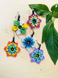 Flower Earrings in multiple colors. These earrings reflect the cultural traditions of indigenous artisans from Chiapas Mexico.  Whether you are looking for everyday jewelry or statement pieces, we got you covered! These beautiful beaded earrings are unique, lightweight, and perfect for any occasion.  They also make great gifts.  * If you would like some more pictures of these lovely earrings don't hesitate to message me. As a special thank you every shipment will receive a FREE GIFT!! Thank you Flower Earrings Dangle, Huichol Earrings, Cultural Traditions, Beautiful Beaded Earring, Mexican Flowers, Earrings Flower, Beaded Dangle Earrings, Lovely Earrings, Beaded Dangles