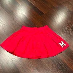 Such A Cute Red Skirt For Gamedays At University Of Maryland! Never Worn And Has Tags On It! Red Skirt With Elastic Waistband For Spring, Red Skirt With Elastic Waistband, Red Cotton Flared Skirt Bottoms, Casual Red Flared Skirt, Red Stretch Tennis Skirt For Summer, Stretch Red Mini Skirt With Lining, Red Stretch Mini Skirt With Lining, Red Bottoms For Cheerleading In Summer, Cheerleading Mini Skirt With Pleated Details