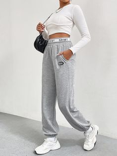 F00215614-103 Sporty Stretch Joggers With Pockets, Solid Color Athleisure Sports Pants, Athleisure Bottoms For Gym During Sports Season, Solid Moisture-wicking Sportswear Pants, Baggy Wide-leg Sports Pants, Solid Color Sportswear Gym Bottoms, Casual Wide Leg Bottoms With Letter Print, Casual Letter Print Bottoms For Winter, Casual Winter Bottoms With Letter Print