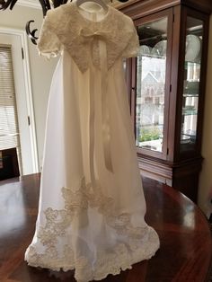 "FREE SHIPPING IN THE U.S. and reduced shipping rates for International orders. This beautiful gown is grandmother's wedding dress conversion, but it can be made new from similar fabric from my shop. Satin bodice with puffed sleeves and a scalloped lace edge. Organza skirt also has the scalloped lace edge. Beautiful large collar in the front with a bow (optional) Satin ribbon ties in the back of the waist. Bridal looping and satin buttons close the back. Matching bonnet included. Gown is made he Ceremony Baptism Dress With Lace Trim And Fitted Bodice, Elegant Fitted Baptism Dress For Church, Fitted Lace Trim Baptism Dress For Wedding, Lace Ball Gown For First Communion At Wedding, Fitted Baptism Dress With Lace Trim For Wedding, Cream Baptism Dress With Fitted Bodice, Wedding Baptism Dress With Fitted Bodice And Ball Gown, Floor-length Lace Trim Gown For Ceremony, Baptism Dress With Fitted Bodice In Ball Gown Style