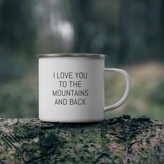 i love you to the mountains and back coffee mug on a tree stump in the woods