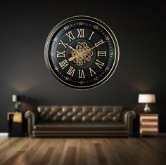 a large black and gold clock on the wall above a couch in a living room