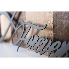 the word happily spelled with metal letters on wood