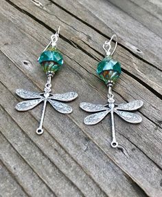 Antique silver dragonfly earrings with Czech crystals, perfect dragonfly gift! These lovely antique silver dragonfly earrings are a great bargain! Lots of detail on the wings with lovely garnet beads. If you're looking for something on the petite side, these are extremely lightweight. Simple yet elegant. If this is a gift you will definitely appreciate the presentation. All of my jewelry comes on my custom butterfly cards and wrapped in a sable black gift box. I am also happy to include gift mes Adjustable Silver Crystal Earrings As Gift, Handmade Silver Dragonfly Jewelry, Silver Dragonfly Earrings Perfect For Gifts, Silver Dragonfly Earrings For Gift, Sterling Silver Dragonfly Earrings, Silver Sterling Dragonfly Earrings, Elegant Sterling Silver Dragonfly Earrings, Dragonfly Wing Earrings, Handmade Green Dragonfly Jewelry