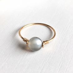 "This beautifully simple ring is lovingly handmade with a Moonstone and a choice of 14k Gold Filled, 14k Rose Gold Filled or Sterling Silver band. M A T E R I A L S: * Grey Moonstone * 14k Gold Filled, 14k Rose Gold Filled or Sterling Silver S I Z E: *  Gemstone - Approximately 6mm *  Band Thickness - Approximately 0.8-1mm  All of our jewellery is carefully handmade using good quality materials and handpicked gemstones, with the aim to produce quality pieces that you can love & wear for years to come.  M O O N S T O N E: * June Birthstone * Talisman for Cancer, Libra & Scorpio * Third Eye Chakra, Solar Plexus Chakra A stone for \"new beginnings\", Moonstone is a stone of inner growth and strength.  It soothes emotional instability and stress, and stabilises the emotions, providing calmness Elegant Handmade Everyday Moonstone Ring, Elegant Everyday Handmade Moonstone Ring, Nature Jewellery, Tiny Pendant Necklace, Pink Gemstone Necklace, Birthstone Stacking Rings, Bracelets Friendship, Wire Craft, Grey Moonstone