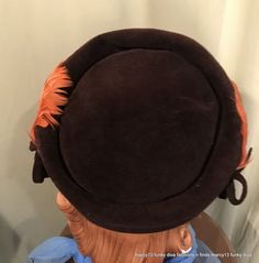 "This is a cute vintage pillbox style hat, that dates from the 1950s or early 60s. Label reads, \"Genuine Velour\". Made of dark brown velour with orange feather on each side, accented by small velour bows. Measures 21\" inside, but is really just a one size hat, as it was made to perch on your head. The hat is in good vintage condition. No wear or soil. Sweet!" Vintage Mini Hats With Curved Brim For Costume, Vintage Brimmed Mini Hats For Costume, Vintage Short Brim Top Hat For Costume, Vintage Mini Hat With Short Brim For Costume, Retro Mini Hats With Short Brim For Vintage Events, Retro Mini Hats With Short Brim For Church, Vintage Brown Hat Bands For Kentucky Derby, Vintage Brown Hat Band For Kentucky Derby, Vintage Short Brim Mini Hat For Costume