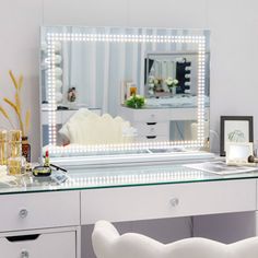 a dressing table with a mirror and lights on it