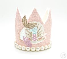 there is a pink crown with pearls on it