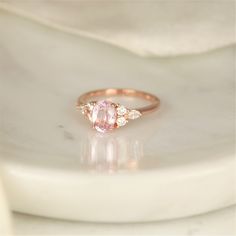 Our Thea ring here would make a great addition to any jewelry collection with her one of a kind center stone that is sure to wow the crowd! #rings #engagementrings #weddignrings #promiserings #selftreat #rosadosbox #rosegold #blush #champagne #sapphire #gemstone #diamonds #artdeco #cluster #oval #jewelry #finejewelry #gifts Luxury Oval Morganite Wedding Ring, Timeless Oval Sapphire Wedding Ring, Oval Morganite Jewelry For Proposal, Heirloom Rose Gold Oval Sapphire Ring, Morganite Oval Rings With Brilliant Cut, Oval Gemstone Ring For Proposal, Elegant Sapphire Ring With Side Stones For Wedding, Wedding Rings With Side Stones In Fine Jewelry Style, Oval Rings With Side Stones For Anniversary