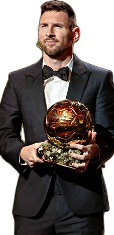 a man in a tuxedo holding an award