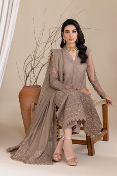 Luxury Grey Embroidered Pakistani Salwar Kameez Dupatta Suit is a beautiful attire that will give you a ravishing look on the festive occasion. Lavish designs, threads, and embellishments make this beautiful Pakistani Party Dress your foremost priority for the big day. Chiffon Kameez: The kameez has chiffon fabric and is emblazoned with lavish floral designs, motifs, and delicate embroidery. Beaming sequins and threads make this beautiful kameez in an alluring grey color a perfect choice to wear for the festive occasion. Raw Silk Trousers: Embroidered kameez is paired with trousers to create a magnificent Pakistani Salwar Kameez. The trousers are in raw silk fabric and their borders are emblazoned with embroidery and lace work. Chiffon Dupatta: Pakistani Salwar Kameez achieves the final ra Pakistani Salwar, Raw Silk Fabric, Organza Sleeves, Net Dress, Readymade Saree, Pakistani Salwar Kameez, Embroidered Organza, Silk Trousers, Pakistani Designers