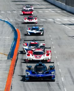 several race cars driving on a track