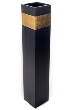 a tall black vase with gold stripes on the bottom and sides, sitting in front of a white background