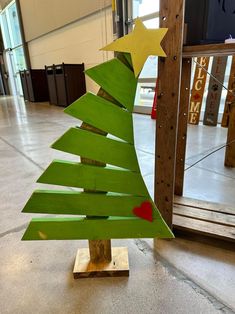 a small wooden christmas tree sitting on top of a table