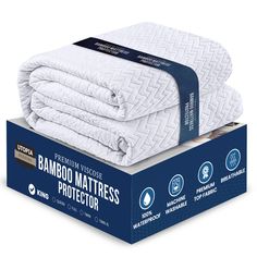 the bamboo mattress protector is folded up on top of an unopened cardboard box