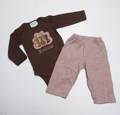 Our Thanksgiving Outfits are a customer favorite!  These gingham pants are perfect for all throughout the fall and on Thanksgiving Day.  Create the perfect Thanksgiving Outfit with the matching turkey shirt!   The pants are made from sturdy cotton gingham for a unique but neutral look!  They're elastic waist for an adjustable fit.  The brown shirts and bodysuits are high quality cotton interlock knit for a soft and comfortable fit.  The turkey is appliqued on and a name can be added underneath f Cotton Gingham Pants For Fall, Gingham Cotton Pants For Fall, Fall Gingham Cotton Pants, Gingham Cotton Bottoms For Fall, Baby Boy Thanksgiving Outfit, Boy Thanksgiving Outfit, Boys Thanksgiving Shirts, Baby Thanksgiving, Baby Turkey