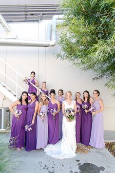 a bride and her bridal party in purple dresses