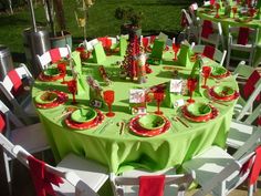 a green table with red and white place settings