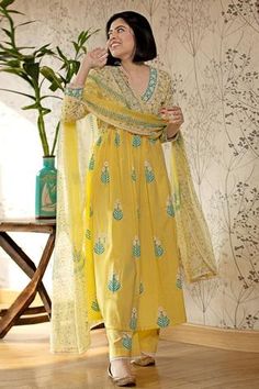 Yellow flared long kurta with floral motif print and lace finish neckline. Paired with pants and chiffon dupatta.
Component: 3
Block Print, Embroidered
Neckline: V Neck
Sleeve Length: Long
Fabric: Cotton Cambric; Dupatta: Chiffon
Color: Yellow
Gathered flare - Aza Fashions डिजाइनर कपड़े, Salwar Kamiz, Fashion Designing, Cotton Kurti, Indian Dress, Kurta With Pants, Suit Designs, Kurta Designs, Indian Designer Wear