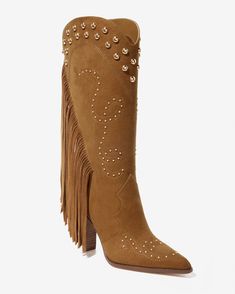 Step out into colder weather in our Fringe Studded Boot. With a luxe suede finish, bold fringe detailing, and eye-catching studded accents, this Western-inspired boot offers effortless pull-on style, making it a standout piece for your seasonal wardrobe. Trendy Boots With Tassels For Fall, Western Boots With Rhinestone Fringe For Fall, Western Rhinestone Fringe Boots For Fall, Leather Fringe Boots For Fall, Winter Suede Boots With Tassels, Western Style Studded Heeled Boots For Fall, Winter Boots With Rhinestone Fringe, Chic Fringe Boots For Winter, Fall Suede Boots With Studs