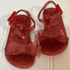 Gymboree | Red Glitter Jelly Sandals With Bow | Toddler 3/4 Nwot Never Worn. Easy On And Off With Velcro Buckle. Holiday Glitter Sandals With Round Toe, Glitter Sandals With Round Toe For Holidays, Cute Red Sandals With Round Toe, Glitter Jelly Sandals With Round Toe For Summer, Glitter Jelly Sandals For Summer, Glitter Round Toe Jelly Sandals For Party, Summer Glitter Jelly Sandals With Round Toe, Red Open Toe Jelly Sandals For Party, Cute Non-slip Sandals For Party