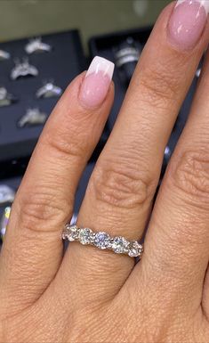 a close up of a person's hand with a wedding ring on their finger