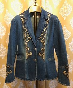 "Regalia" is a beautiful one of a kind fitted denim blazer, hand painted wearable work of art by Jaki Katz Ashford. Approximate size XS. Painted with indelible French fabric paints and embellished with heat set amber colored Swarovski crystals. Medium blue antique wash stretch denim Approximate size 2-4 2 front buttons 2 sewn closed pockets Light shoulder pads Pointed collar middle back Fitted waist Rear vent 24" sleeve from shoulder 16" across back at shoulders 24" length from shoulder in front 36" around bottom Fitted Western Spring Outerwear, Fitted Western Style Spring Outerwear, Fitted Denim Blazer For Fall, Fitted Western Outerwear For Spring, Fitted Western Style Outerwear For Spring, Western Style Fitted Blazer For Fall, Hand Painted Fitted Cotton Outerwear, Casual Fitted Embroidered Blazer, Fitted Western Denim Jacket