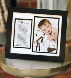 a black and white photo frame with an image of a baby on it's chest