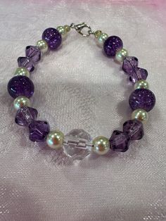 Handmade beaded bracelet, perfect as a small gift! Elegant Stretch Bracelet With Large Beads For Gift, Elegant Stretch Bracelet With Large Beads As Gift, Elegant Handmade Rosary Bracelet With Round Beads, Handmade Crystal Bracelet With Round Beads For Gift, Handmade Crystal Bracelet With Round Beads As Gift, Purple Beaded Bracelets With Spacer Beads As Gift, 8mm Round Beads Bracelets For Crafting, Purple Beaded Bracelets With Round Beads For Gifts, Beaded Crystal Bracelet Gift