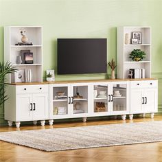 a white entertainment center with shelves and a flat screen tv