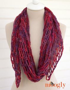 a mannequin wearing a red and purple scarf