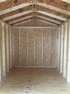 an empty room with wooden floors and walls in the process of being built by someone