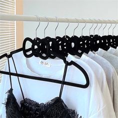 some clothes hanging on a rack in front of a window