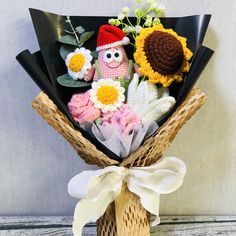 a bouquet of crocheted flowers in a basket