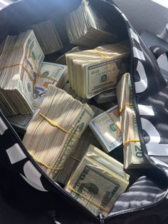 a bag filled with money sitting on top of a table