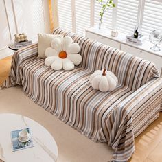 a striped couch with two stuffed flowers on it