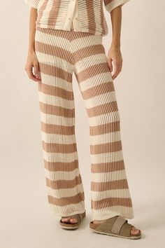 Striped crochet-knit pants. Banded elastic waist. Wide leg. Thigh-length shorts lining. Ankle length. Relaxed fit. 60% Cotton, 40% Acrylic. Imported. Designed in LA. Model wears size S. Casual Striped Ribbed Bottoms, Cozy Ribbed Cotton Bottoms, White Knit Wide-leg Pants, White Knit Bottoms For Fall, White Knit Wide Leg Pants, Casual White Knitted Bottoms, White Stretch Knit Pants, Cozy Stretch Knitted Bottoms, Stretch Knitted Casual Bottoms