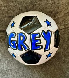 a soccer ball with the word grey painted on it